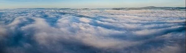 Sunrise illuminates the marine layer covering the entirety of San Francisco Bay. The foggy marine layer is an almost daily climatic phenomenon