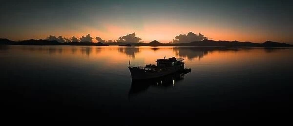 Sunrise illuminates the sky over the calm waters of the Solomon Islands. This scenic region is known for its spectacular marine biodiversity