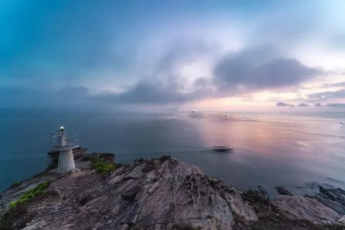 Framed Print : Sunrise by the sea with a lighthouse on the cliff Framed Print : Sunrise by the sea with a lighthouse on the cliff