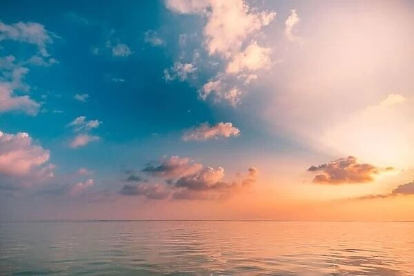 Sunrise sunset seascape with dramatic clouds and beautiful golden light at a tropical beach, sun rays. Stunning relax zen ocean view, horizon scenic