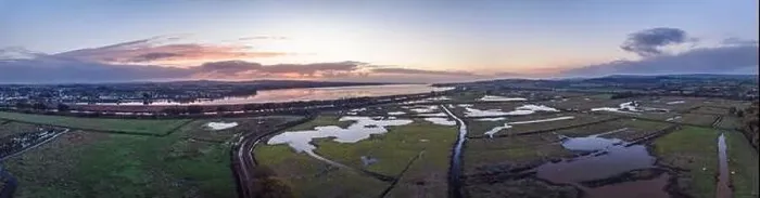 Framed Print : Sunrise over Wetlands and meadows in RSPB Exminster and Powderham Marshe from a drone, Exeter, Devon, England Framed Print : Sunrise over Wetlands and meadows in RSPB Exminster and Powderham Marshe from a drone, Exeter, Devon, England