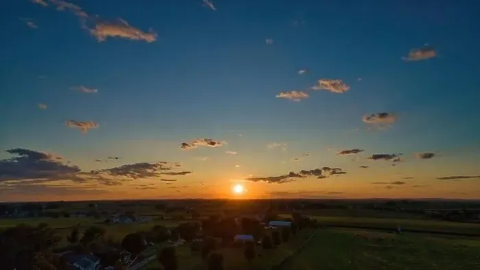 Framed Print : Sunset over barns, silos and green farmlands with blue, red and orange skies and a few clouds Framed Print : Sunset over barns, silos and green farmlands with blue, red and orange skies and a few clouds