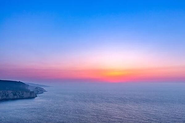 Sunset landscape with cliffs and amazing sunset sky in the north side of Zakynthos island, Greece