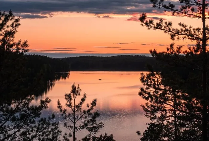 Framed Print : Sunset landscape with peaceful lake and row boat at summer night in Finland Framed Print : Sunset landscape with peaceful lake and row boat at summer night in Finland