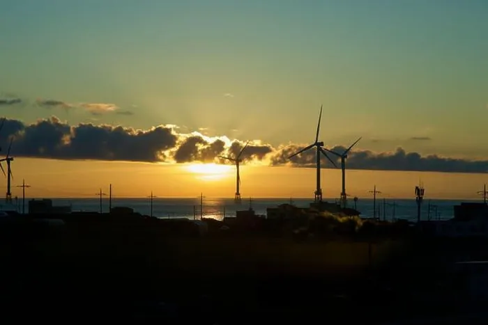 Framed Print : Sunset light breaks beneath cloud bands behind offshore wind turbines and utility poles along Jeju's northwest shore Framed Print : Sunset light breaks beneath cloud bands behind offshore wind turbines and utility poles along Jeju's northwest shore