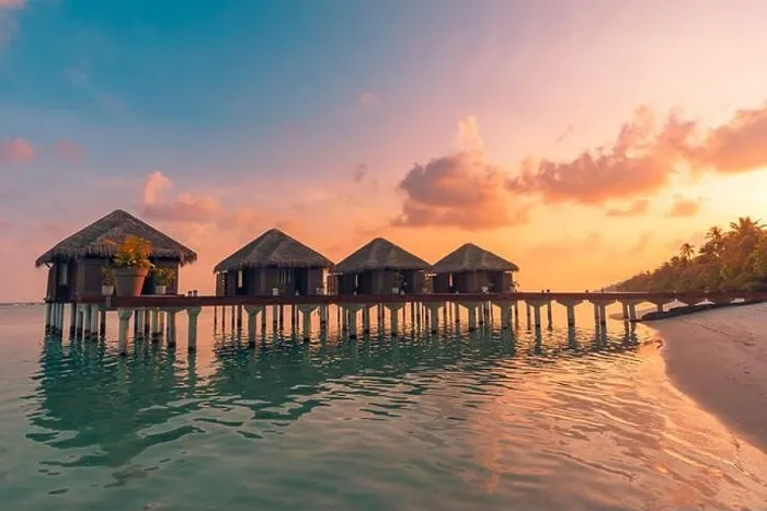 Framed Print : Sunset on Maldives island, luxury water villas resort hotel and wooden pier. Colorful sky and clouds and beach background for summer vacation holiday Framed Print : Sunset on Maldives island, luxury water villas resort hotel and wooden pier. Colorful sky and clouds and beach background for summer vacation holiday