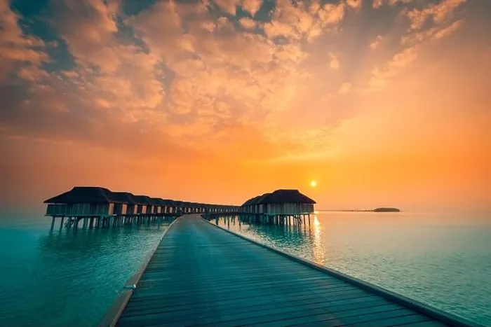 Framed Print : Sunset on Maldives island, luxury water villas resort and wooden pier. Beautiful sky and clouds and beach background for summer vacation holiday Framed Print : Sunset on Maldives island, luxury water villas resort and wooden pier. Beautiful sky and clouds and beach background for summer vacation holiday