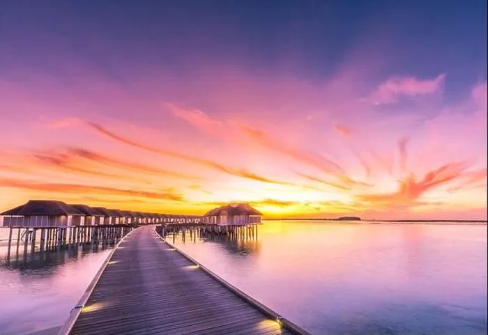 Framed Print : Sunset on Maldives island, luxury water villas resort and wooden pier. Beautiful sky and clouds and beach background for summer vacation holiday Framed Print : Sunset on Maldives island, luxury water villas resort and wooden pier. Beautiful sky and clouds and beach background for summer vacation holiday