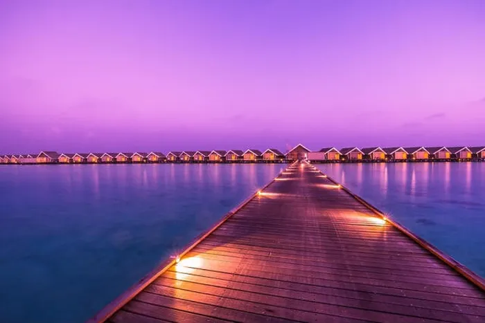 Framed Print : Sunset on Maldives island, luxury water villas resort and wooden pier. Beautiful sky and clouds and beach background for summer vacation holiday Framed Print : Sunset on Maldives island, luxury water villas resort and wooden pier. Beautiful sky and clouds and beach background for summer vacation holiday
