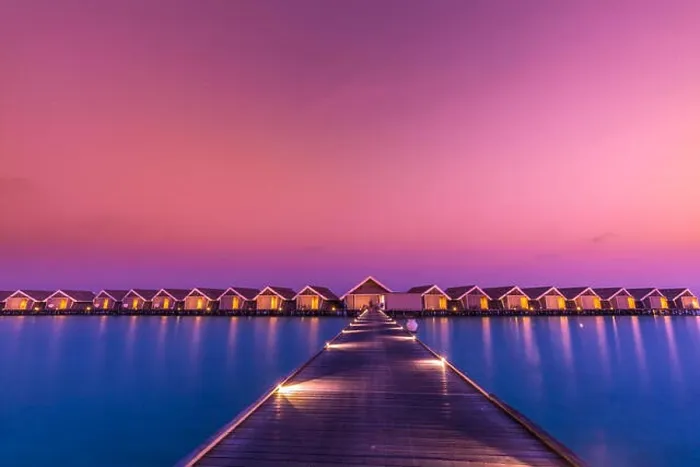 Framed Print : Sunset on Maldives island, luxury water villas resort and wooden pier. Beautiful sky and clouds and beach background for summer vacation holiday Framed Print : Sunset on Maldives island, luxury water villas resort and wooden pier. Beautiful sky and clouds and beach background for summer vacation holiday