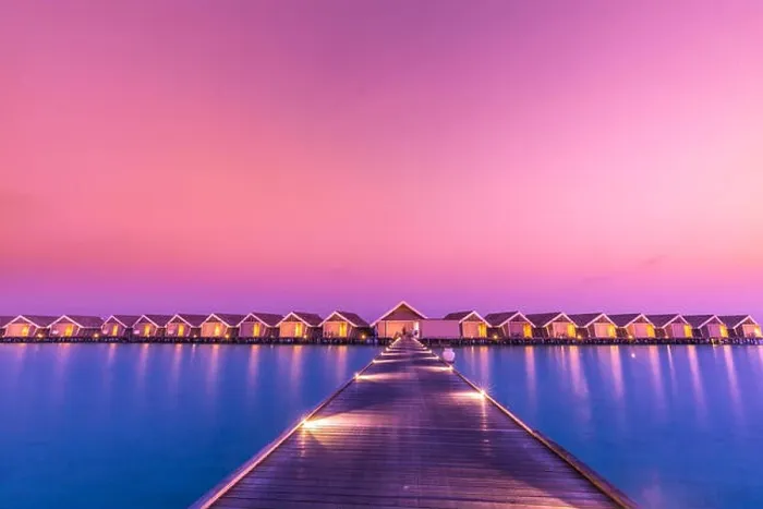 Framed Print : Sunset on Maldives island, luxury water villas resort and wooden pier. Beautiful sky and clouds and beach background for summer vacation holiday Framed Print : Sunset on Maldives island, luxury water villas resort and wooden pier. Beautiful sky and clouds and beach background for summer vacation holiday