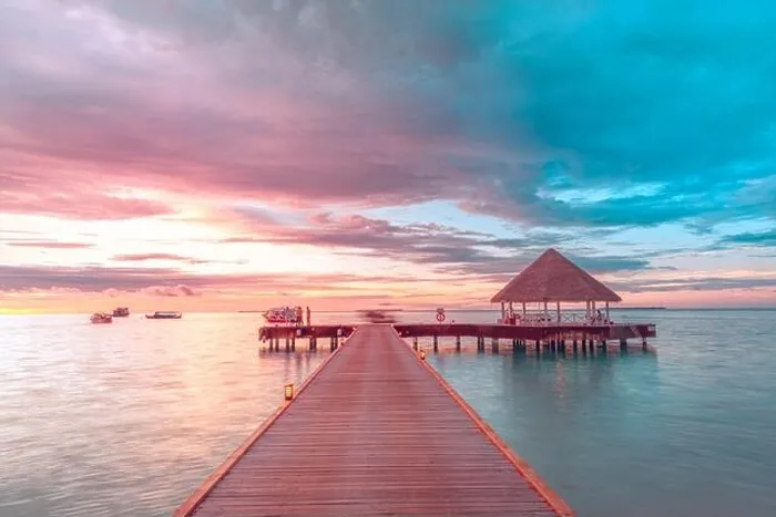 Framed Print : Sunset on Maldives island, luxury water villas resort and wooden pier. Beautiful sky and clouds and beach background for summer vacation holiday