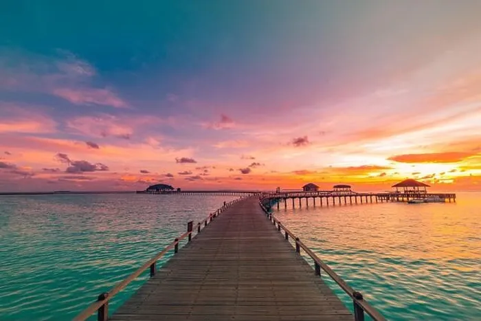 Framed Print : Sunset on Maldives island, luxury water villas resort and wooden pier. Beautiful sky and clouds and beach background for summer vacation holiday Framed Print : Sunset on Maldives island, luxury water villas resort and wooden pier. Beautiful sky and clouds and beach background for summer vacation holiday
