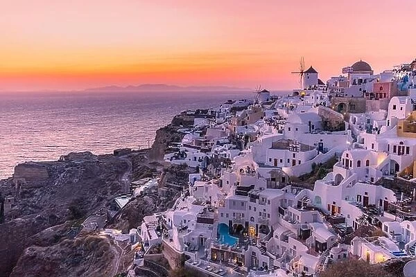 Sunset night view of traditional Greek village Oia on Santorini island in Greece. Iconic travel destination landscape in Greece, famous scenic