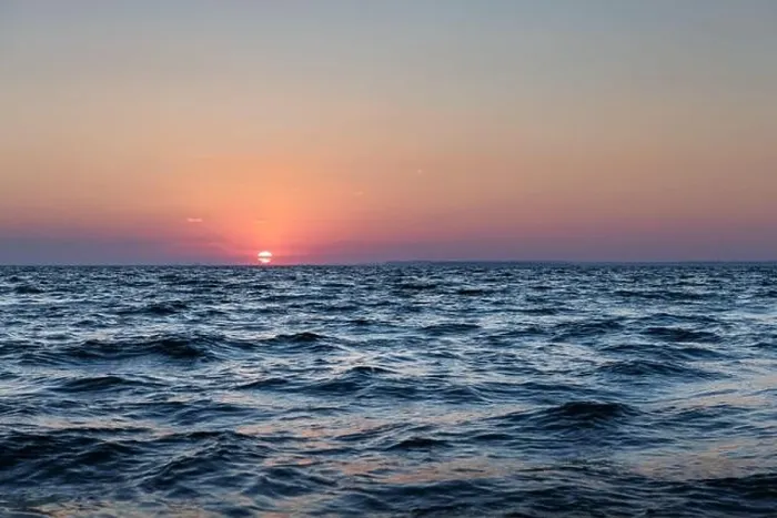 Framed Print : Sunset in the ocean with large sun dusk soft waves and red cloudy sky. Sea sunrise background. Landscape photography