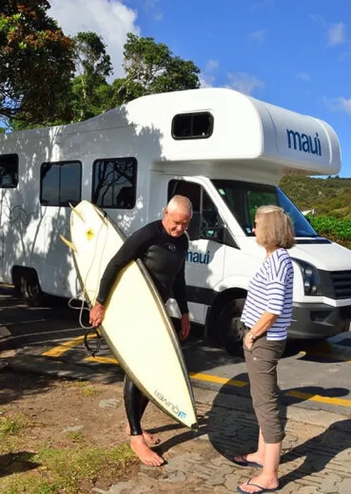 Framed Print : Surfer( male) talking to motorhomer (woman) on Hot Water Beach with the Maui Platinum Beach motorhome behind Framed Print : Surfer( male) talking to motorhomer (woman) on Hot Water Beach with the Maui Platinum Beach motorhome behind