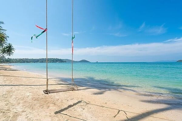 Swing hang from coconut palm tree over summer beach sea in Phuket, Thailand. Summer, Travel, Vacation and Holiday concept