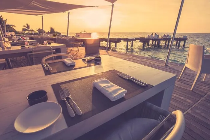 Framed Print : Table dinner setting at the beach on twilight time in tropical shoreline, relaxing mood Framed Print : Table dinner setting at the beach on twilight time in tropical shoreline, relaxing mood