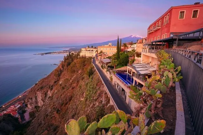 Framed Print : Taormina, Sicily, Italy. Cityscape image of picturesque town of Taormina, Sicily with volcano Mt. Etna in the background at sunrise Framed Print : Taormina, Sicily, Italy. Cityscape image of picturesque town of Taormina, Sicily with volcano Mt. Etna in the background at sunrise