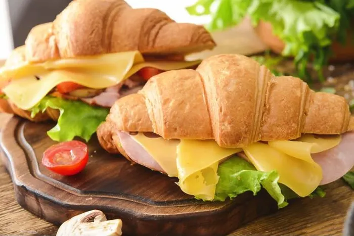 Framed Print : Tasty croissant sandwiches on wooden board Framed Print : Tasty croissant sandwiches on wooden board