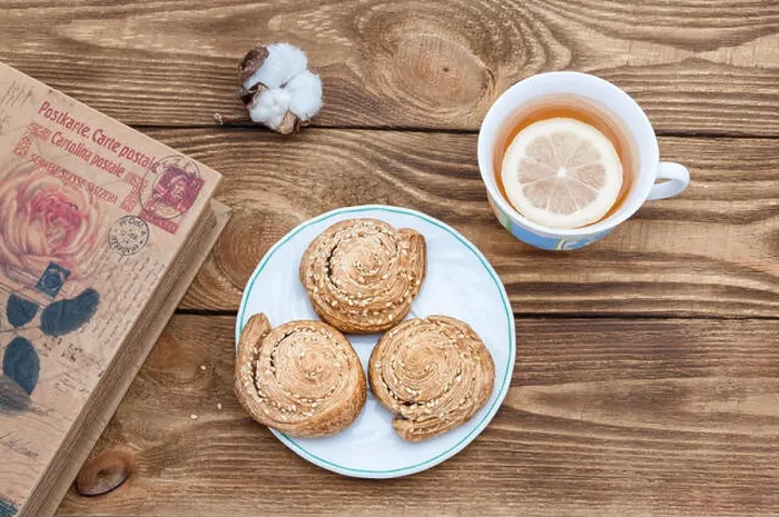 Framed Print : Tea with lemon and homemade cookies and a book on a wooden table Framed Print : Tea with lemon and homemade cookies and a book on a wooden table