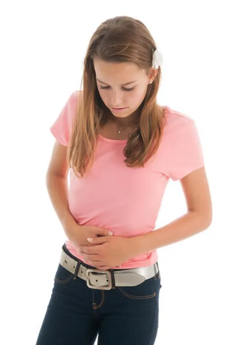 Framed Print : Teen girl with belly ache isolated over white background Framed Print : Teen girl with belly ache isolated over white background