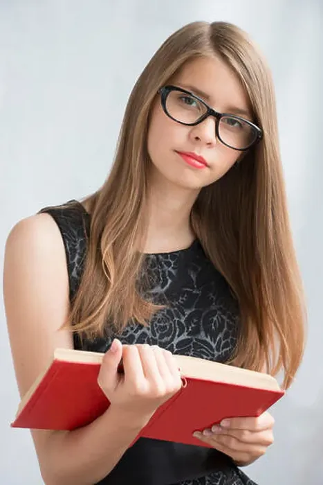Framed Print : Teenage girl in glasses with books Framed Print : Teenage girl in glasses with books