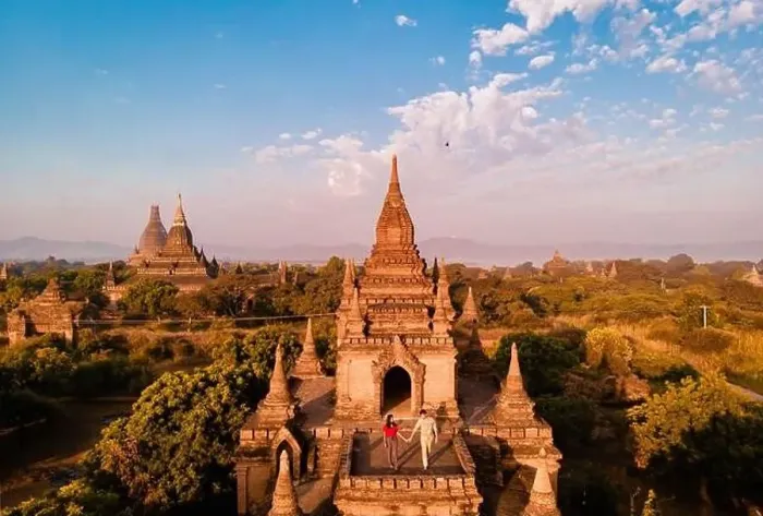 Framed Print : A temple surrounded by trees under a blue sky with fluffy clouds Framed Print : A temple surrounded by trees under a blue sky with fluffy clouds