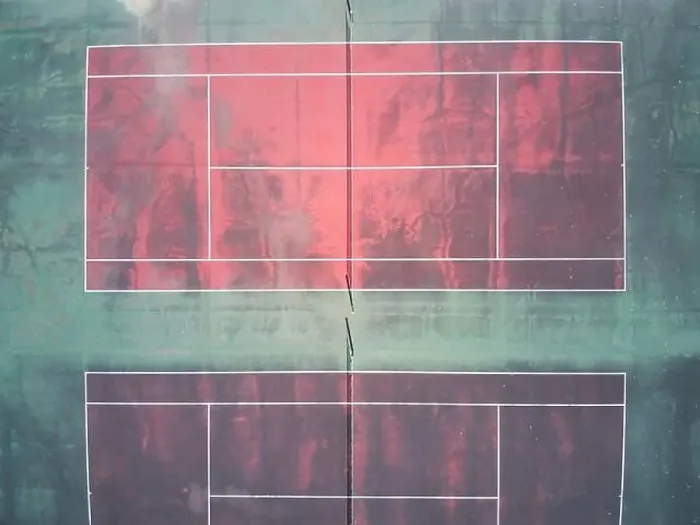 Framed Print : Empty tennis court aerial view showing a red surface court with green edges and white marking lines Framed Print : Empty tennis court aerial view showing a red surface court with green edges and white marking lines
