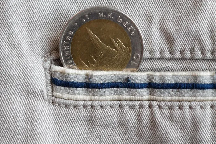 Framed Print : Thai coin with a denomination of 10 baht in the pocket of beige denim jeans with blue stripe Framed Print : Thai coin with a denomination of 10 baht in the pocket of beige denim jeans with blue stripe