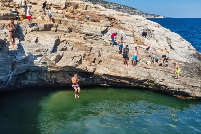 Framed Print : Thassos, Greece - July 20, 2019: Tourists are doing diving in the natural swimming pool Giola in Thassos island, Greece Framed Print : Thassos, Greece - July 20, 2019: Tourists are doing diving in the natural swimming pool Giola in Thassos island, Greece