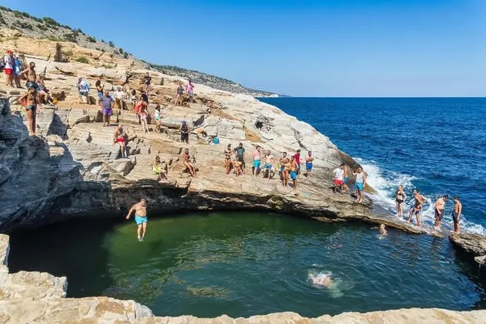 Framed Print : Thassos, Greece - July 20, 2019: Tourists are doing diving in the natural swimming pool Giola in Thassos island, Greece Framed Print : Thassos, Greece - July 20, 2019: Tourists are doing diving in the natural swimming pool Giola in Thassos island, Greece