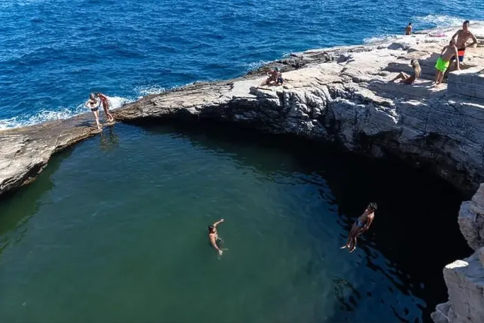 Framed Print : Thassos, Greece - July 20, 2019: Tourists are doing diving in the natural swimming pool Giola in Thassos island, Greece Framed Print : Thassos, Greece - July 20, 2019: Tourists are doing diving in the natural swimming pool Giola in Thassos island, Greece