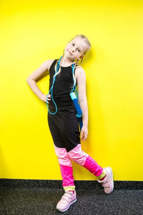 Framed Print : Theme sport and health. Beautiful caucasian child girl with pigtails posing yellow background with smile Framed Print : Theme sport and health. Beautiful caucasian child girl with pigtails posing yellow background with smile