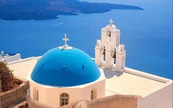 Thira (capital of Santorini) - View at greek church with blue dome, bell tower and blue sea, Santorini Island, Cyclades, Greece