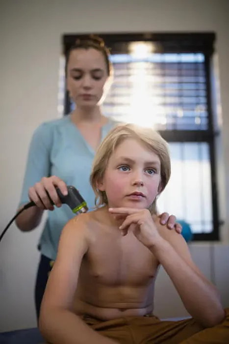 Framed Print : Thoughtful shirtless boy sitting with female therapist using ultrasound machine on shoulder at hospital ward Framed Print : Thoughtful shirtless boy sitting with female therapist using ultrasound machine on shoulder at hospital ward