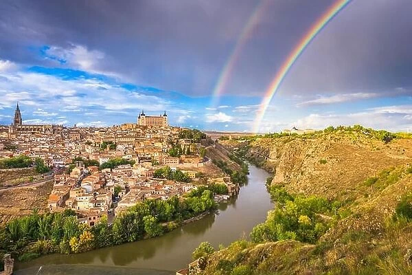Toledo, Spain old town skyline with a rainbow