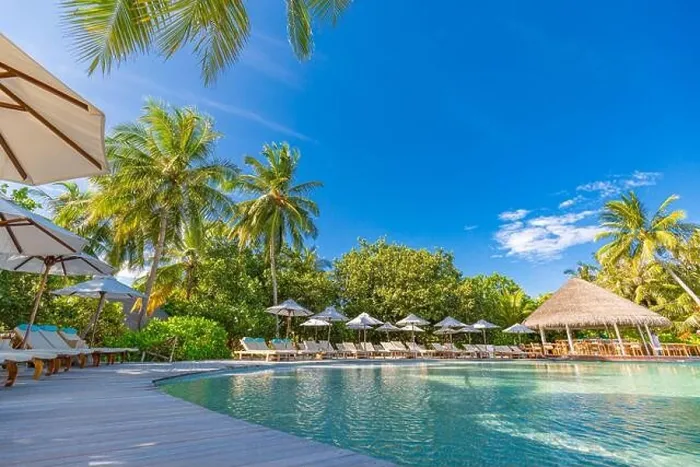 Framed Print : tourism landscape. Luxurious beach resort with swimming pool and beach chairs or loungers under umbrellas with palm trees and blue sky. Summer island Framed Print : tourism landscape. Luxurious beach resort with swimming pool and beach chairs or loungers under umbrellas with palm trees and blue sky. Summer island