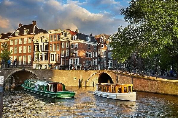 Tourist boat at Amsterdam bridge canal - Holland, Netherlands