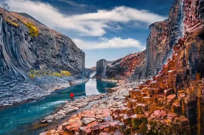Framed Print : Tourist walking on the bottom of canyon with basalt columns Framed Print : Tourist walking on the bottom of canyon with basalt columns