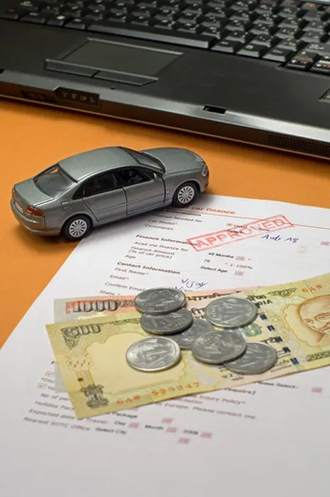 Framed Print : Toy car with loan application form, indian rupees and a laptop Framed Print : Toy car with loan application form, indian rupees and a laptop