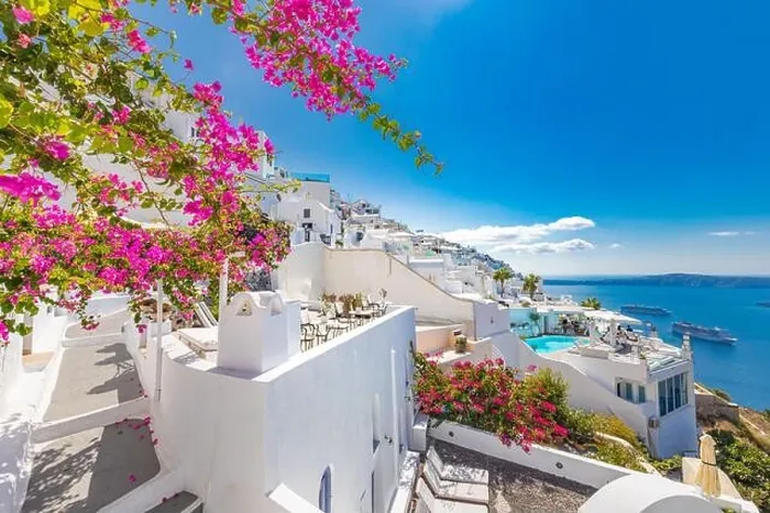 Framed Print : Traditional famous white blue houses wih flowers under sunny weather over the Caldera, Aegean sea. Beautiful summer landscape, sea view, luxury travel Framed Print : Traditional famous white blue houses wih flowers under sunny weather over the Caldera, Aegean sea. Beautiful summer landscape, sea view, luxury travel