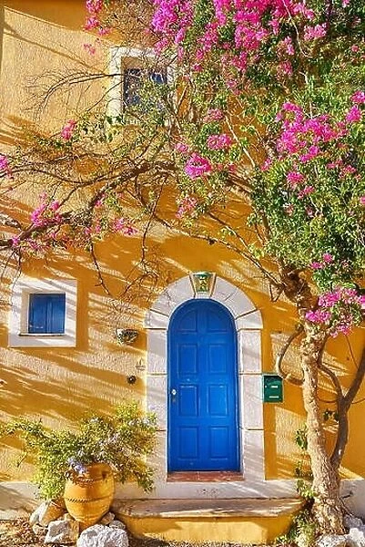 Traditional greek house with bougainvillea blooming flowers, Assos village, Kefalonia Island, Greece