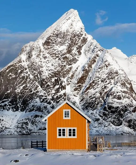 Framed Print : A traditional yellow Rorbu cabin with Mount Olstinden peak set as a dramatic background in the village of Sakrisoya Framed Print : A traditional yellow Rorbu cabin with Mount Olstinden peak set as a dramatic background in the village of Sakrisoya