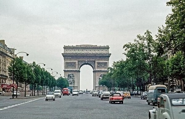 Traffic at the Arc de Triomphe in Paris. Morning commuter traffic. Archival shot scanned from transparency; 1972. Scanned images may prove a little n