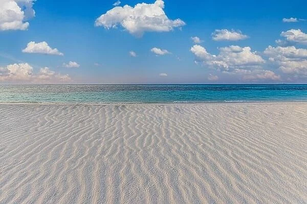 Tranquil beach landscape. Tropical island paradise, shore coast, seaside with cloudy blue sky and soft white sand with ripples. Calm relaxing sea