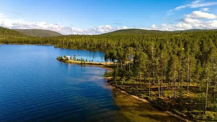 Framed Print : A tranquil, forested lake in Finnish Lapland with clear blue water and a lush green shoreline Framed Print : A tranquil, forested lake in Finnish Lapland with clear blue water and a lush green shoreline