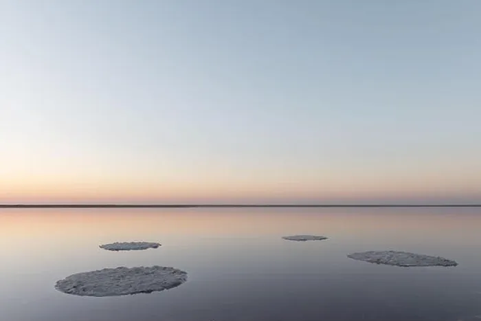 Framed Print : Tranquil minimalist landscape with smooth surface of the pink salt lake with calm water with horizon with clear sky in sunrise time Framed Print : Tranquil minimalist landscape with smooth surface of the pink salt lake with calm water with horizon with clear sky in sunrise time
