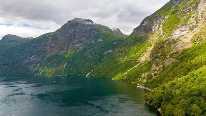 Framed Print : A tranquil scene of a Norwegian fjord surrounded by verdant mountains and a sparkling blue water surface Framed Print : A tranquil scene of a Norwegian fjord surrounded by verdant mountains and a sparkling blue water surface