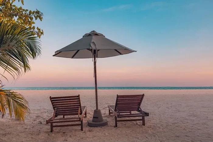 Framed Print : Tranquil tropical sunset landscape, couple sun beds, loungers, umbrella under palm leaves colorful twilight sky. Romance love honeymoon concept Framed Print : Tranquil tropical sunset landscape, couple sun beds, loungers, umbrella under palm leaves colorful twilight sky. Romance love honeymoon concept